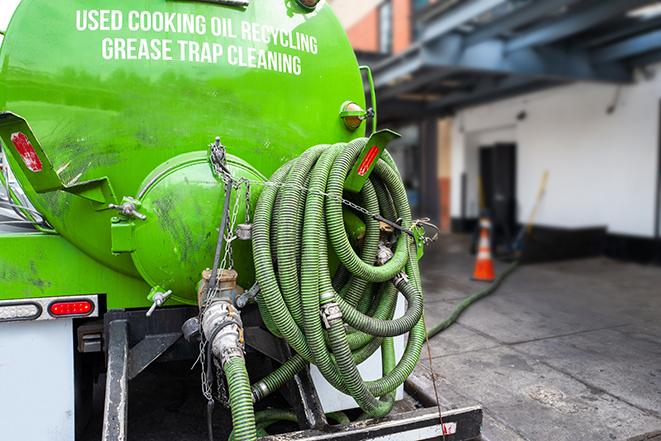 a grease trap pumping truck at a restaurant in Lake Worth